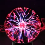A close-up of a plasma ball with vibrant pink and purple electrical discharges emanating from the center, creating a mesmerizing visual display.