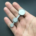 Small magnetic science gadget held in hand, demonstrating magnetic attraction and repulsion for educational purposes.