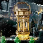 An ornate Victorian-style snow globe featuring intricate gold accents and a detailed architectural design, set against a snowy winter backdrop.