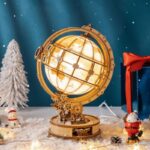 Decorative wooden globe with gears, set against a winter-themed background with snow, Christmas tree, and holiday decorations. Perfect for educational or festive decor.