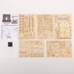 Detailed view of wooden model train kit parts, including circuit boards, gears, and assembly instructions for educational and hobby use.