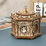 Intricate wooden mechanical music box featuring a carousel design with detailed carvings and rotating parts, perfect for educational decor and science-inspired gifts.