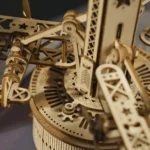 Detailed close-up of a wooden mechanical clock model showcasing gears, levers, and intricate craftsmanship. Perfect for science decor and educational toy displays.