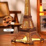 Detailed wooden Eiffel Tower model illuminated with warm lights, perfect for decor and educational purposes. Includes a Type-C charging port for easy power supply.