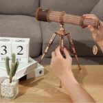 Wooden telescope model with adjustable tripod, perfect for science lovers and educational decor. Crafted from wood, it offers a realistic look for science-themed spaces.