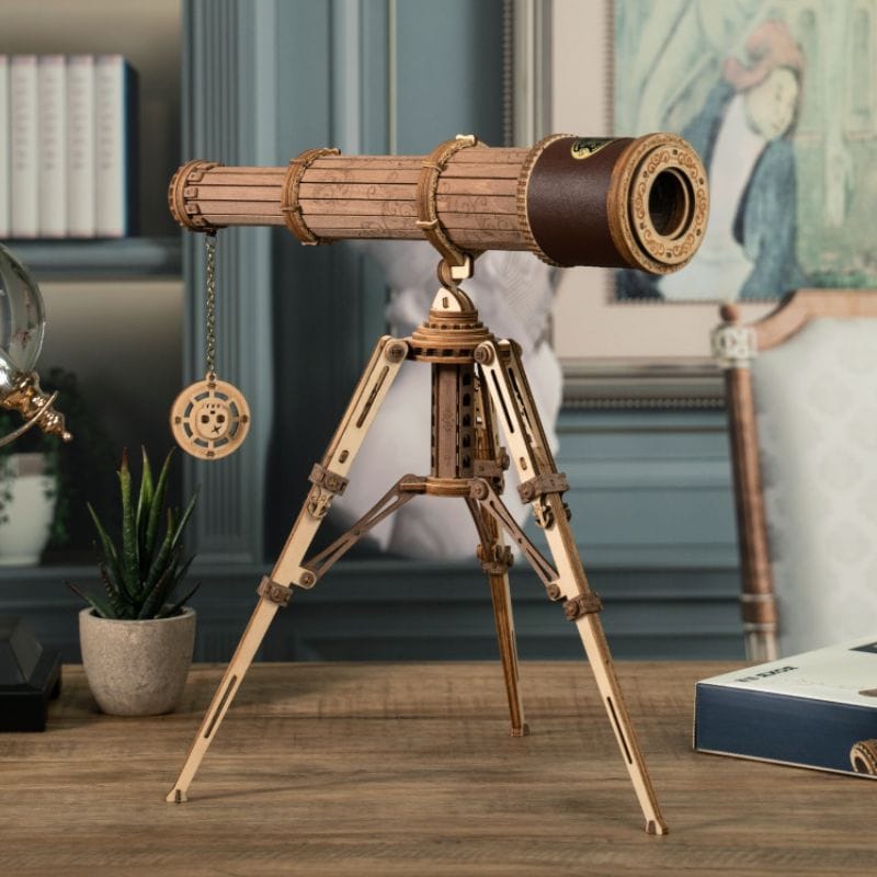Wooden telescope model on a wooden table, perfect for astronomy and science education, with a detailed tripod and vintage design.