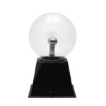A Tesla coil model resembling a light bulb with a metallic sphere on top, mounted on a black base, used for science demonstrations and educational purposes.