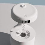 Modern air quality monitor with digital clock, humidifier, and sleek white design for home or office use.