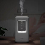 Modern white air humidifier emitting mist with LED light, ideal for home or office use, promoting better air quality and humidity levels.