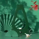 Elegant green lamp with origami cranes and fans, creating a stylish and artistic decor piece.