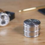 Modern stainless steel magnetic desk organizer with three compartments, ideal for storing small office supplies or personal items on a workspace.