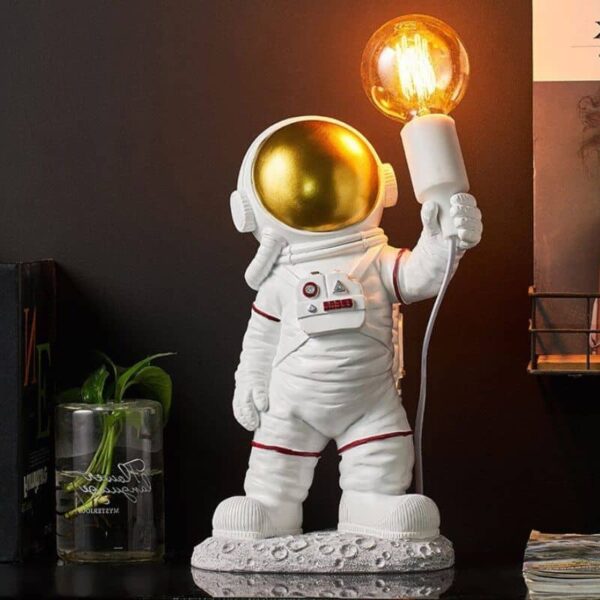 Cute astronaut figurine holding a glowing light bulb, perfect as a decorative piece or educational toy for space enthusiasts.