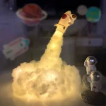 A detailed model of a space rocket launching with a smoke effect, surrounded by astronaut figures and planetary backgrounds, perfect for educational and decorative purposes.