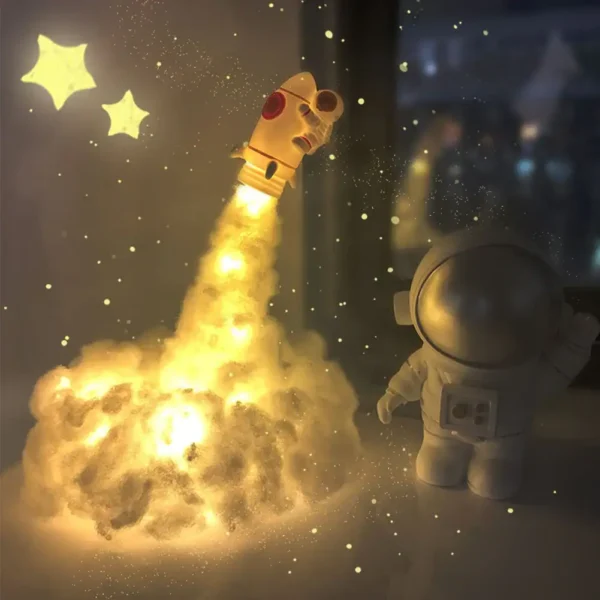 A toy rocket launching with a glowing cloud and star-shaped lights, creating a space-themed decorative scene.