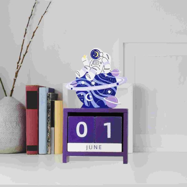 Decorative space-themed desk calendar featuring an astronaut, planets, and swirling galaxy design, perfect for science enthusiasts and educational decor.