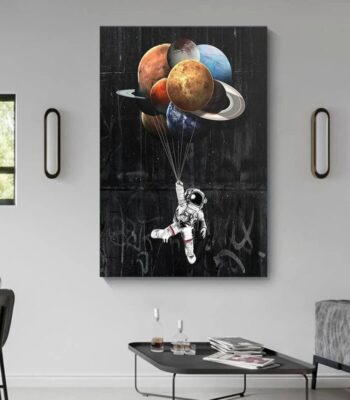 Astronaut holding balloons shaped like planets, creating a cosmic scene on a black background.