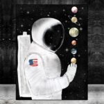 Artistic depiction of an astronaut in space holding planets, including Saturn and Earth, against a starry background. Perfect for science decor and educational toys.