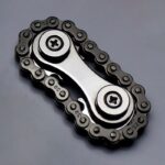Close-up of a metallic bicycle chain and sprocket gear assembly, showcasing the detailed links and teeth against a neutral background.