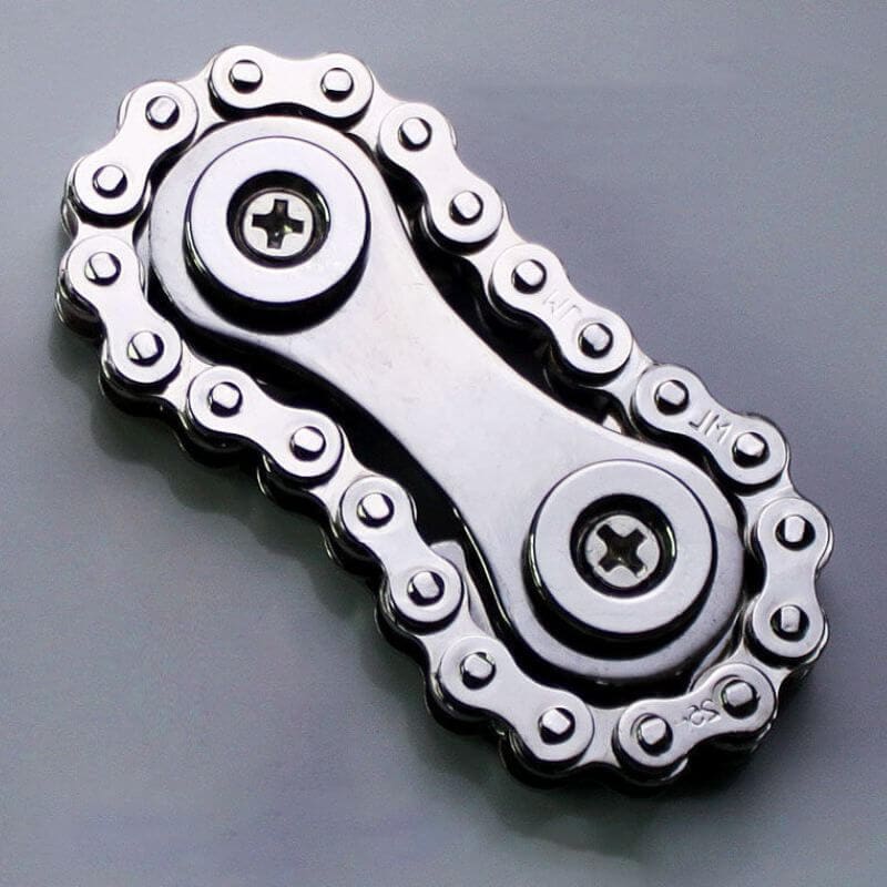 Close-up of a metallic bike chain link with detailed sprockets, showcasing mechanical precision and engineering design.