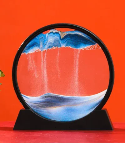 Interactive magnetic water and oil display with colorful swirling patterns on a round glass surface, set against a vibrant orange background.