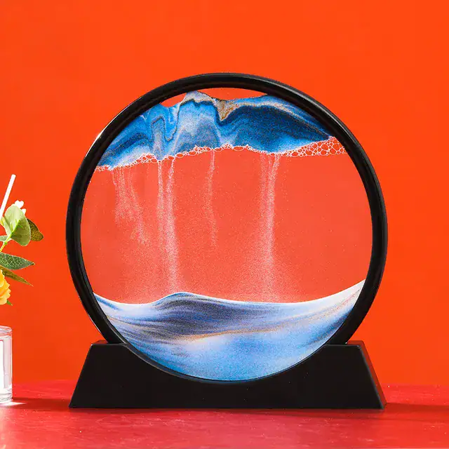 Interactive magnetic water and oil display with colorful swirling patterns on a round glass surface, set against a vibrant orange background.