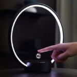 Modern magnetic levitation desk lamp with a glowing ring and floating sphere, demonstrating innovative science decor and educational technology.