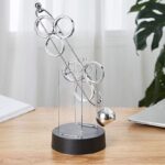 Educational magnetic science toy with metal rings and ball, demonstrating magnetic forces and physics principles.