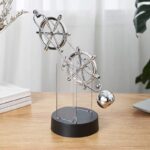 Metal planetary gear model for science decor and educational purposes, featuring interconnected gears and a metallic sphere, displayed on a wooden surface with a bright, modern background.