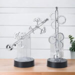 Elegant glass science-themed balance and ring tower decor pieces for educational and decorative purposes.