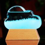 A cloud-shaped nebula lava lamp with glowing blue liquid, creating a mesmerizing celestial display on a wooden base. Perfect for science decor and educational purposes.