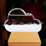 Clear acrylic cloud-shaped science decor with dry ice creating fog effect, mounted on a wooden base, ideal for educational displays and science-themed decor.