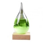 Glass science flask with green liquid on wooden base.
