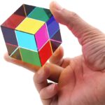 Hand holding a colorful magnetic puzzle cube with vibrant, interlocking pieces, demonstrating a fun and educational toy for all ages.