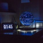 Illuminated star map globe night light displaying constellations and celestial patterns in a dark room, perfect for science decor and educational purposes.