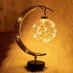 Decorative moon-shaped lamp with warm fairy lights for cozy ambiance.