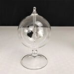 Elegant glass globe with internal metallic components for science experiments and decor.