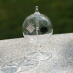 Transparent glass sphere with magnetic metal blocks inside, demonstrating magnetic attraction and repulsion, ideal for science experiments and educational demonstrations.