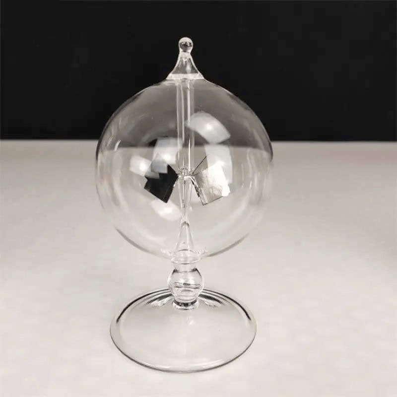 Elegant glass globe with internal metallic components for science experiments and decor.
