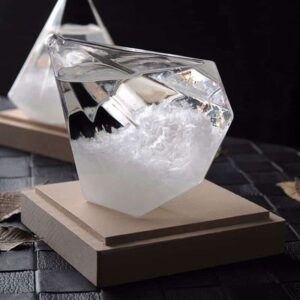 Glass cube with water and ice, showcasing scientific principles of states of matter.