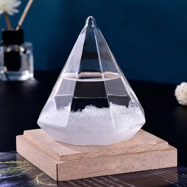 A clear, pyramid-shaped scientific glass container filled with a liquid, placed on a wooden base for display.