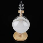 Clear glass chemistry flask with a round bottom, wooden stand, and stopper, used for scientific experiments and educational demonstrations.