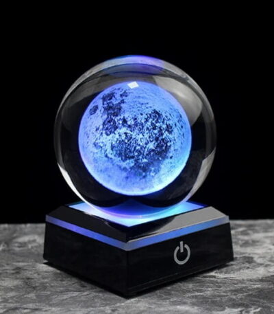 Illuminated moon globe night light with a glowing blue surface, placed on a black base with power button, ideal for science decor and educational purposes.