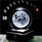 A 3D moon lamp showcasing detailed lunar surface features, illuminated against a dark background with moon phase images above.