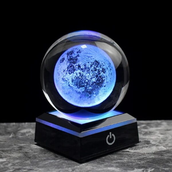 Illuminated moon globe night light with a glowing blue surface, placed on a black base with power button, ideal for science decor and educational purposes.