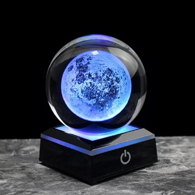 Illuminated moon globe night light with a glowing blue surface, placed on a black base with power button, ideal for science decor and educational purposes.
