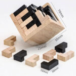 Educational wooden block puzzle with black and natural wood pieces, measuring 50mm, 25mm, and 10mm, designed for cognitive development and fun.