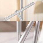 Sleek silver metallic floor lamp with minimalist design, featuring a slim cylindrical base and adjustable arm, ideal for contemporary home decor.