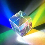Transparent glass cube projecting vibrant rainbow colors through light refraction, ideal for science-themed decor and educational displays.
