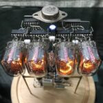Close-up of a vintage nixie tube clock showcasing glowing numerals and electronic circuitry, perfect for science decor and educational displays.