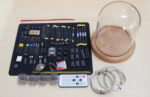 Educational science experiment kit with various electronic components, wires, and tools for hands-on science projects and STEM learning.